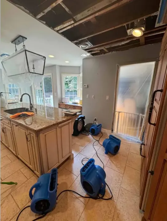 Air movers running in a Beaverton kitchen after a water leak