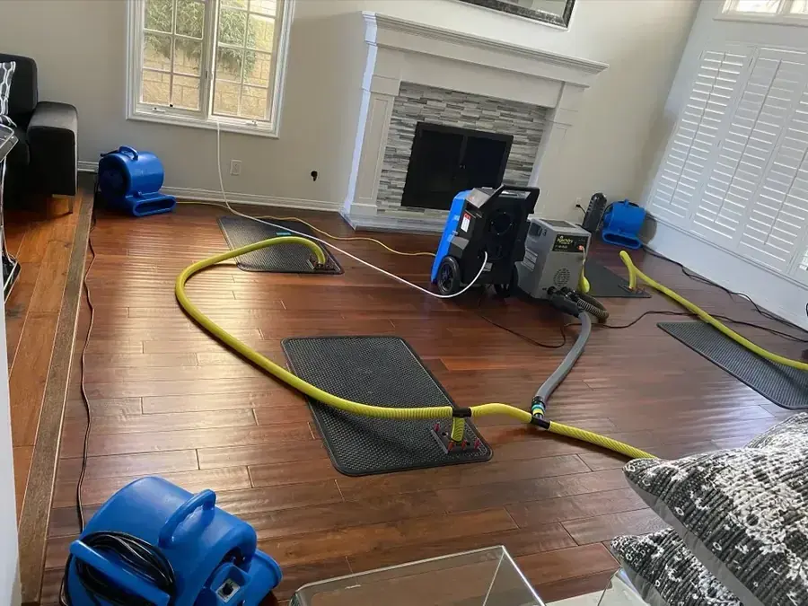 Air movers and floor drying mats drying a hardwood living room in Beaverton
