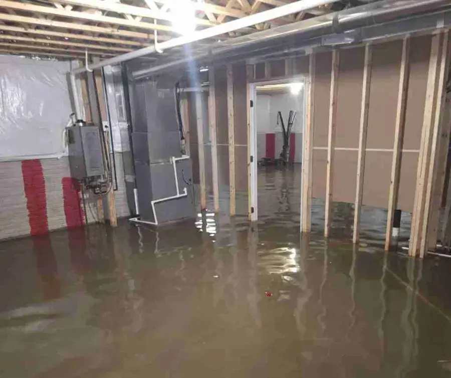 Standing water across an unfinished basement in Beaverton