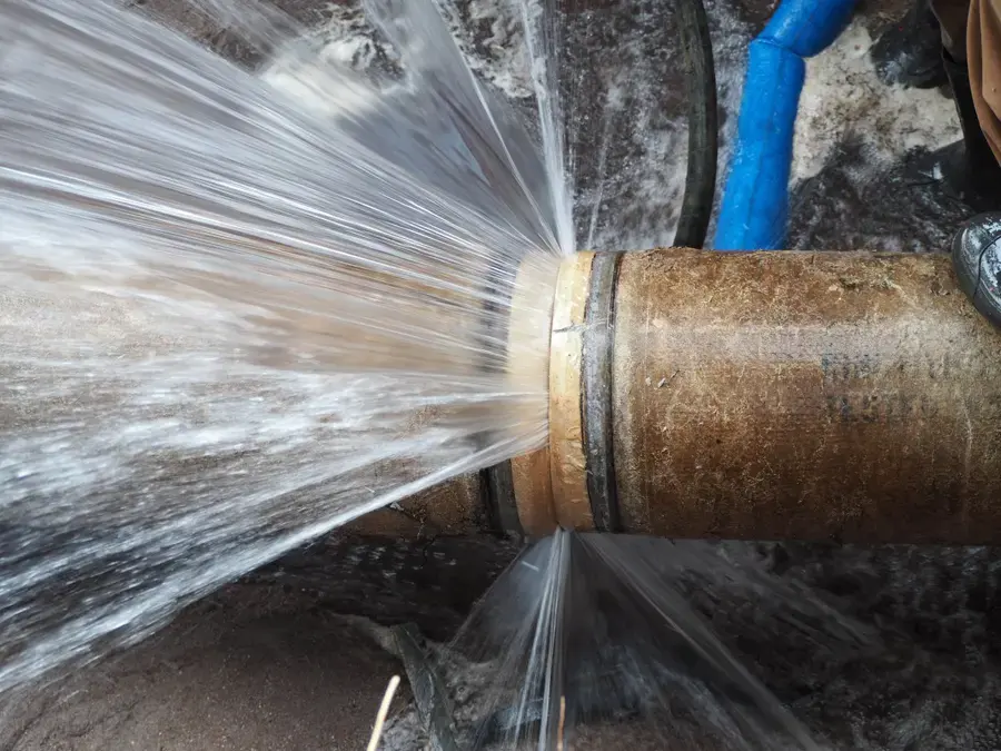 Water spraying from a split supply pipe in Beaverton