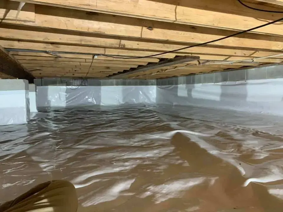 Rainwater pooled on the vapor barrier of a Beaverton crawlspace