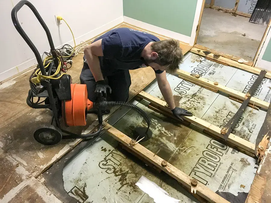 Drain line being cleared during a sewage backup cleanup in Beaverton